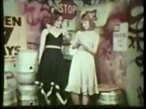 Vintage clip of two yummy hottie lesbian lovers making love on some beer kegs