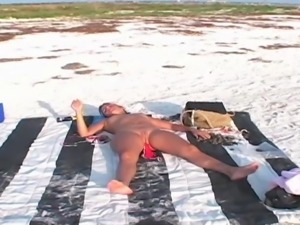 Nude Sunbathing and Sucking Cock on a Public Beach