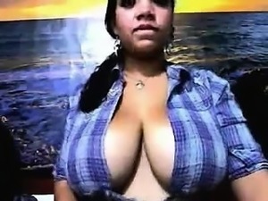 This lady has busty boobs. She shows her huge assets in