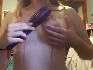 Lewd slender cam bitch pours some wax on her natural small tits