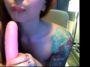 Tattooed slut fucks her creamy pussy